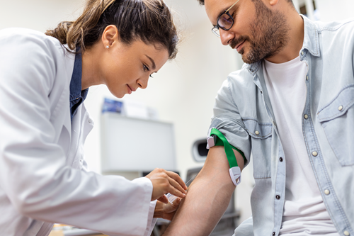 2friendly-hospital-phlebotomist-collecting-blood-sample-from-patient-lab-preparation-blood-test-by-female-doctor-medical-uniform-table-white-bright-room
